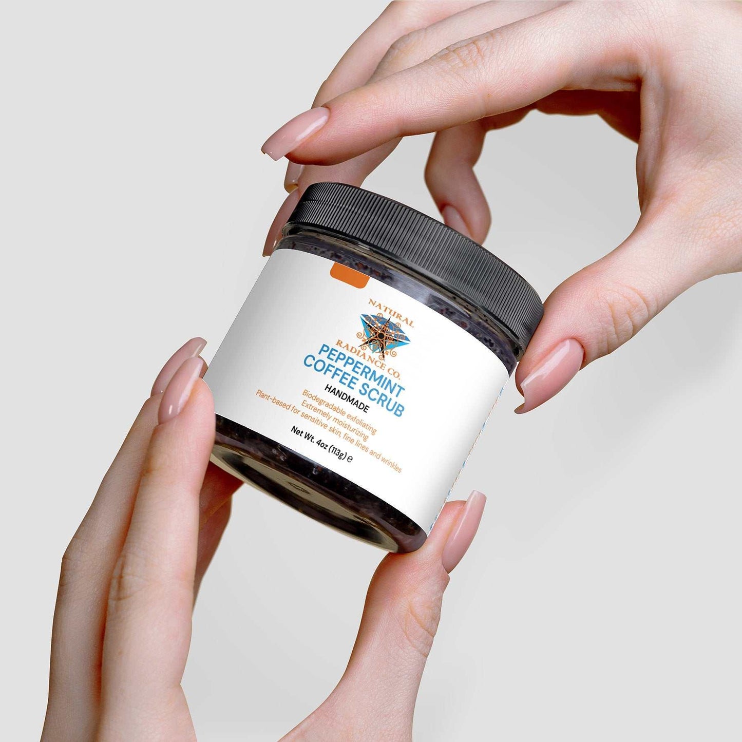 Peppermint Coffee Scrub jar held in hands, showcasing rejuvenating and exfoliating skincare benefits.