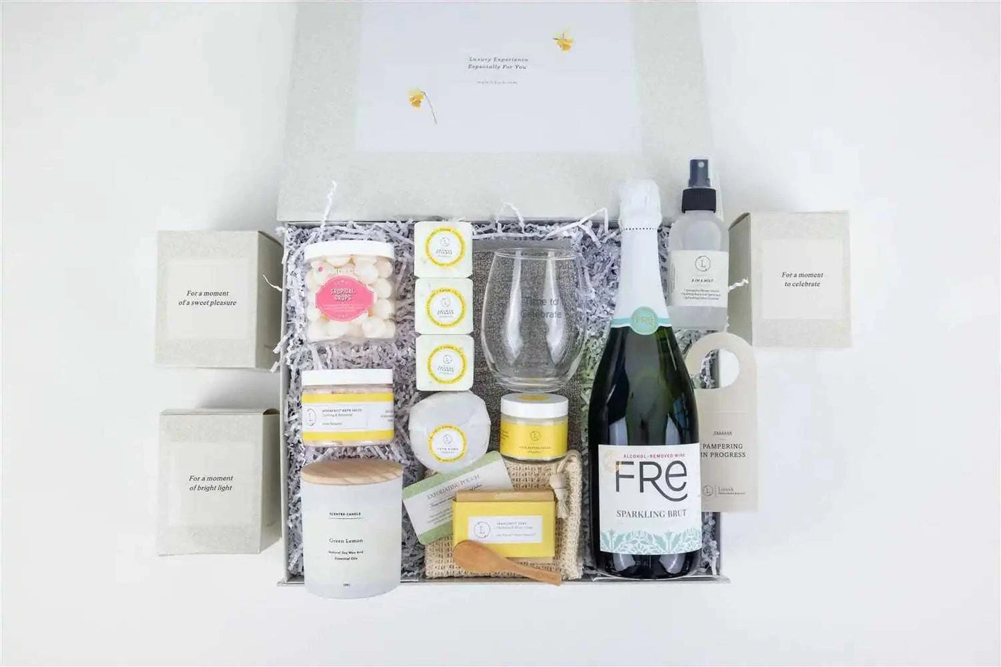 Congratulations gift basket with wine, candle, grapefruit bath products, and personalized options in a celebratory gift box.