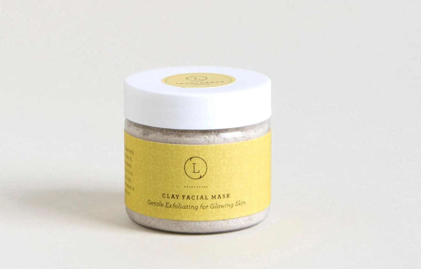 Christmas gift box featuring a clay facial mask with yellow label for gentle exfoliation and glowing skin.