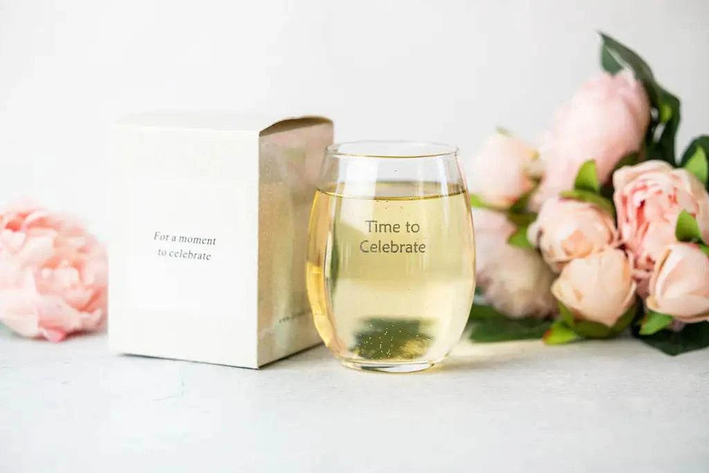 Celebration gift box with wine glass and pink flowers, perfect for congratulations gift basket.