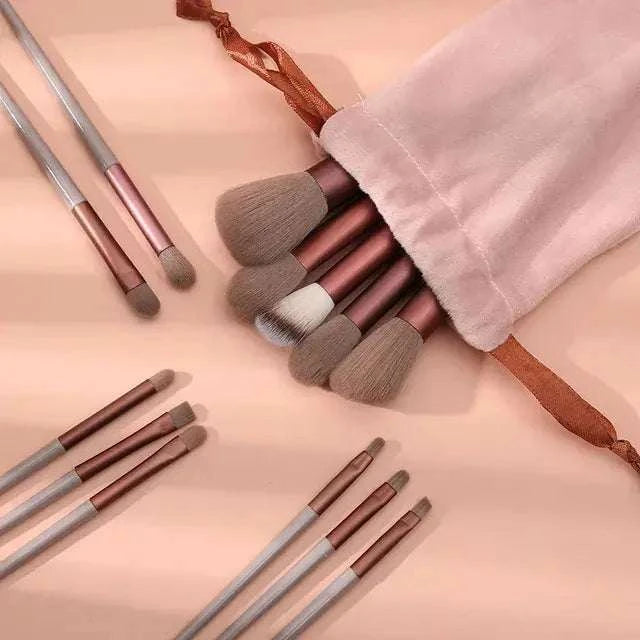 Soft fluffy makeup brushes set in a pink pouch for luxurious beauty application.