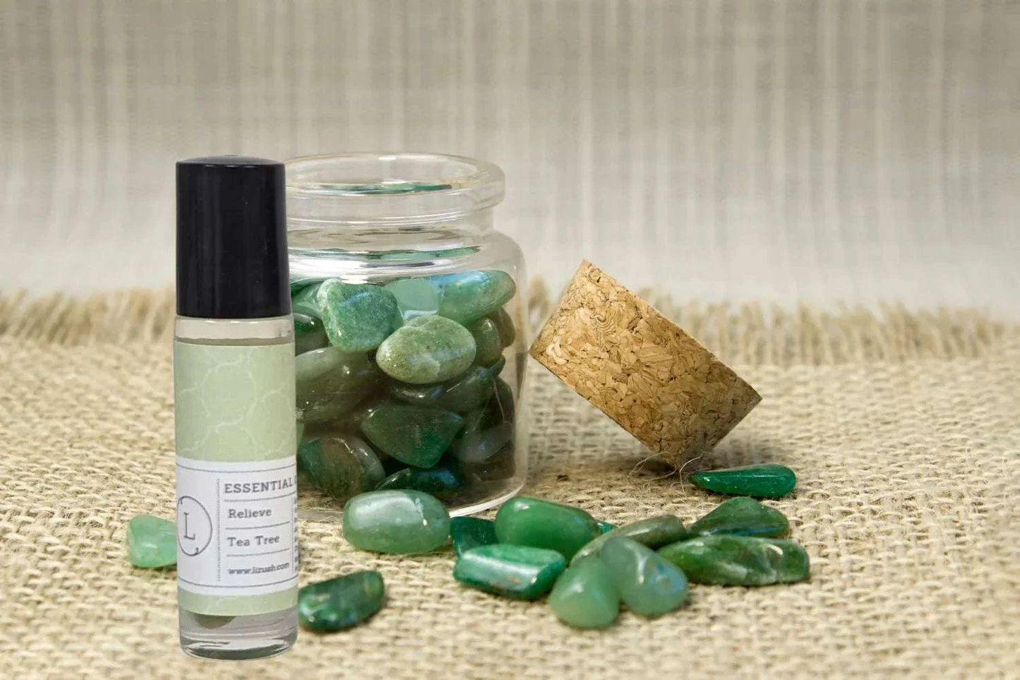 Essential Oils Roll-On Set with Crystals and CBD on display with green crystals in a jar.
