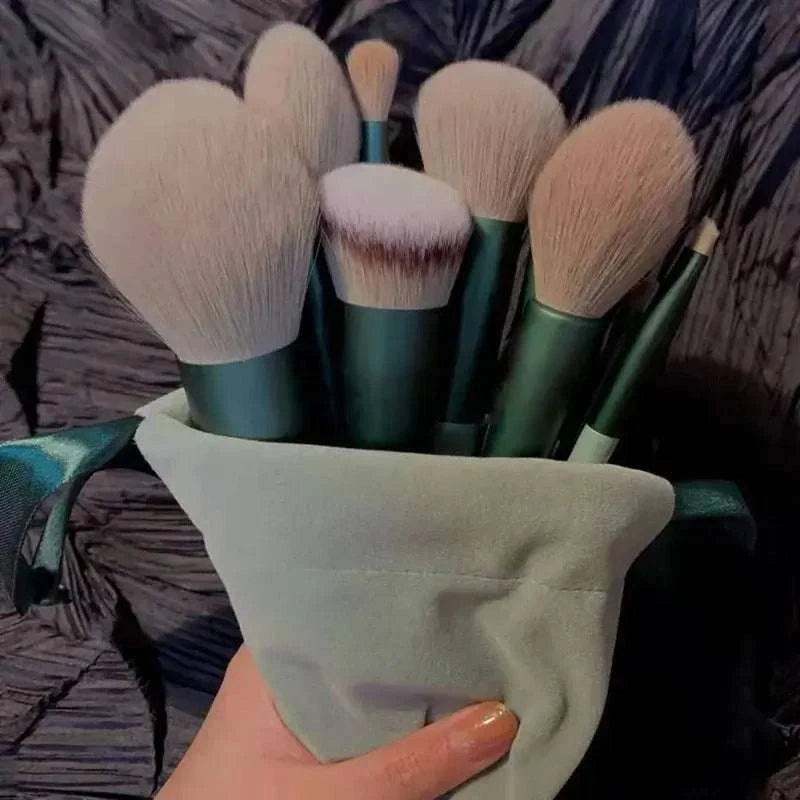 Soft fluffy makeup brushes set in a light pouch for luxurious beauty application.