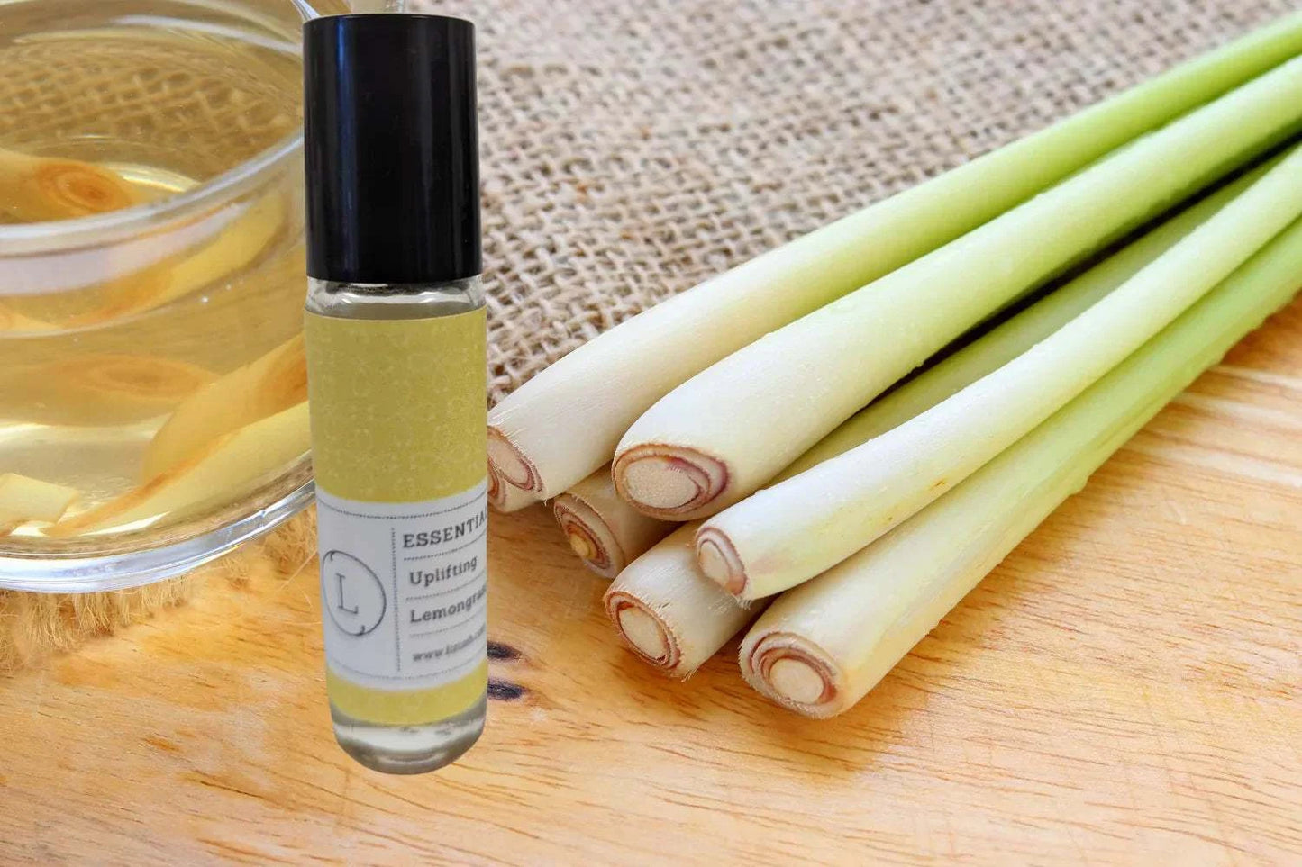 Essential Oils Roll-On with Lemongrass and Crystals on Wooden Surface