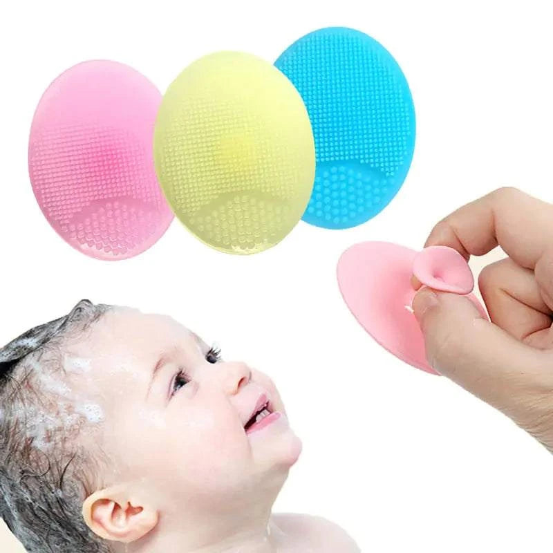 Silicone facial exfoliating cleansing brush with soft bristles in pink, yellow, and blue for gentle deep cleaning.
