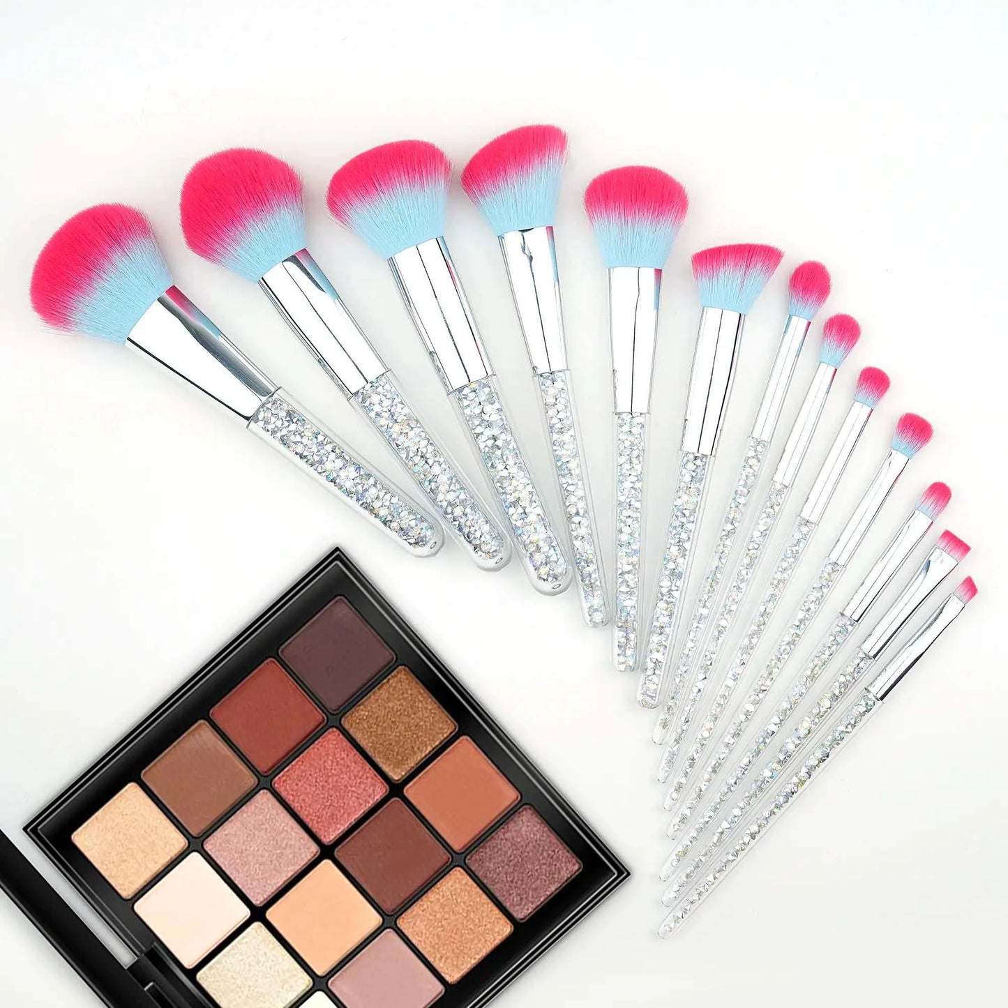 Frost Candy Vegan Brushes set with colorful bristles and glittery handles next to a makeup palette.