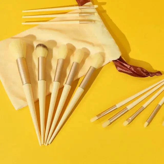 Soft fluffy makeup brushes set with sleek handles displayed with a pouch on a bright background.