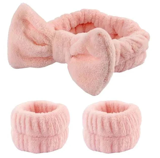 Plush pink bow hair and wristband set for skincare routine.