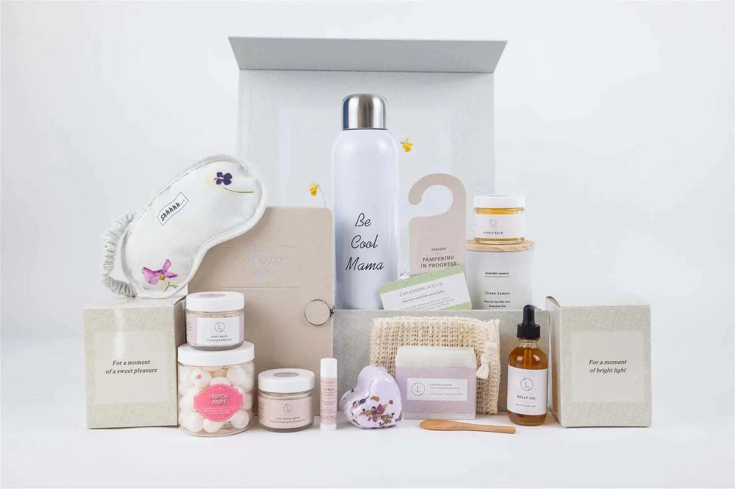 New mom pampering natural skincare gift set with nipple balm, belly oil, water bottle, scented candle, journal, lavender soap, foot salt, candy sparkle, shower steamer, clay mask, lip balm, eye mask, soap saver, and door hangtag in a customizable box.
