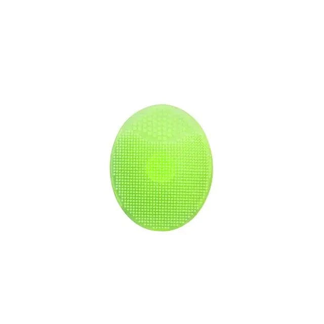 Green silicone facial exfoliating cleansing brush for deep skincare.