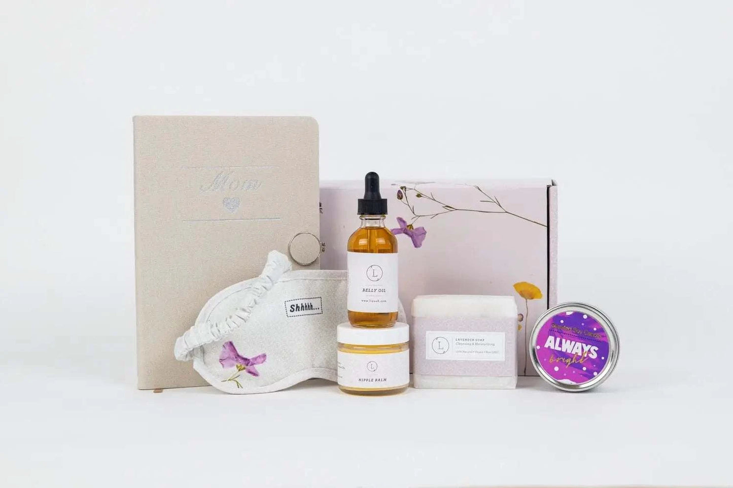 Pregnancy gift box with nipple balm, belly oil, scented soy candle, journal, lavender soap, eye mask, personalized packaging.