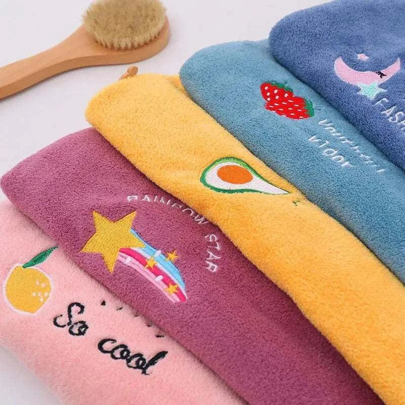 Magic Hair Towel in vibrant colors with playful embroidery designs.