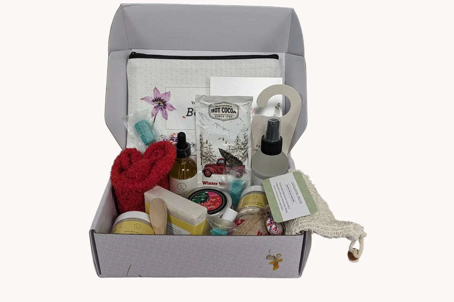 Christmas gift box with spa essentials including grapefruit soap, body oil, eucalyptus shower mist, red socks, and more for a luxurious holiday pampering experience.