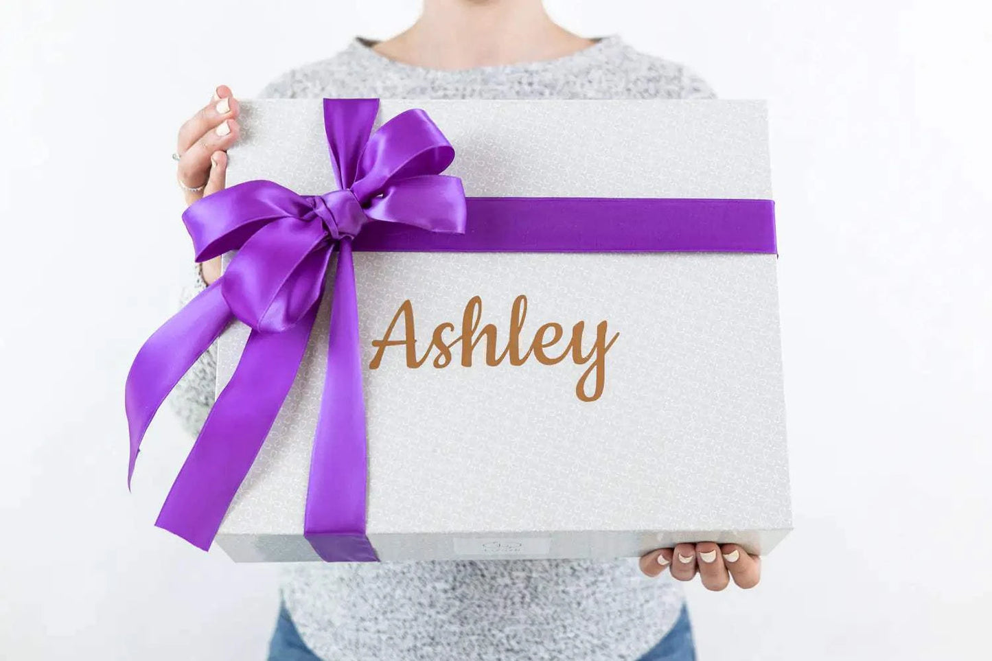 Pampering natural skincare gift box for new mom with purple ribbon.