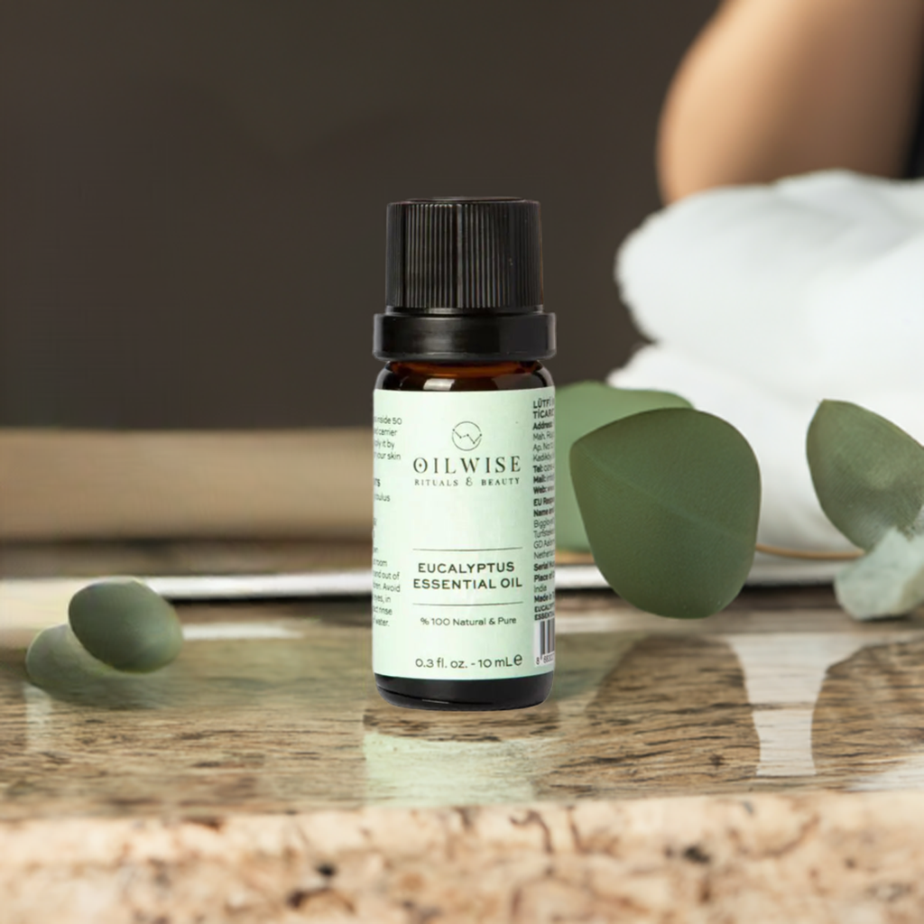Oilwise Eucalyptus Essential Oil bottle with leaves, emphasizing purity and therapeutic benefits.