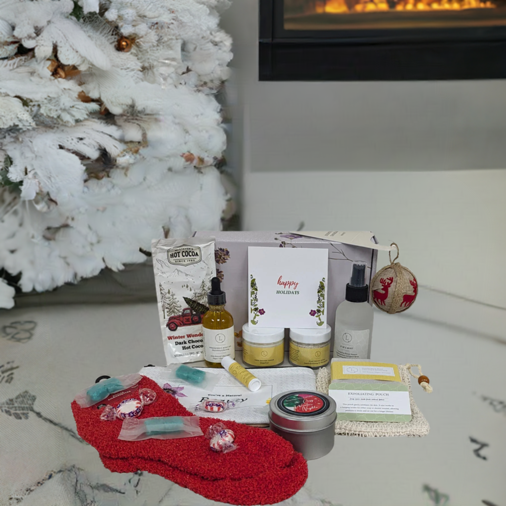 Christmas gift box with spa essentials and pampering items under a decorated tree.