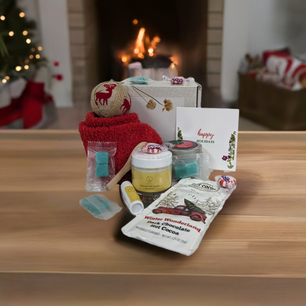 Christmas gift box for cozy nights with bath products, candle, socks, hot cocoa, and personalized greeting card.