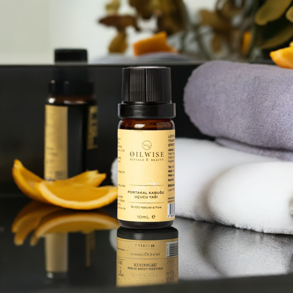 Oilwise Orange Peel Oil 10 ml bottle with slices of orange peel and towels in the background, ideal for aromatherapy.