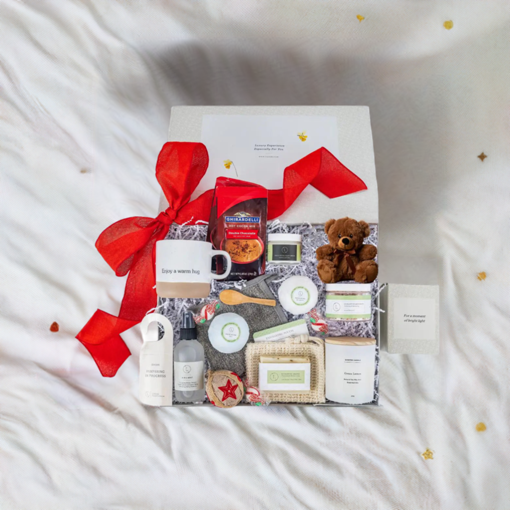 Valentine's Day luxury spa gift set with scented candles, eucalyptus bath salts, a ceramic mug, teddy bear, and peppermint candies.