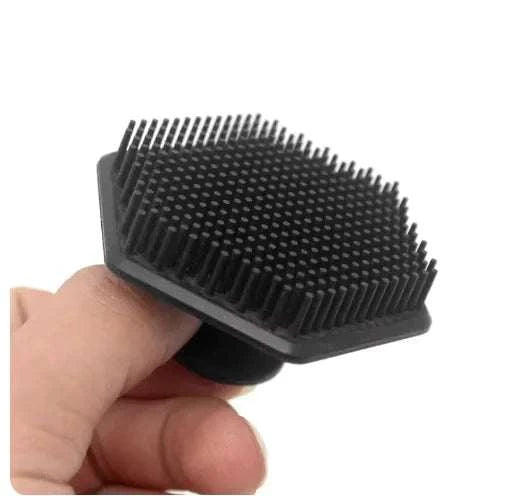Miniature silicone facial cleaning brush with soft bristles for deep cleansing and exfoliation.