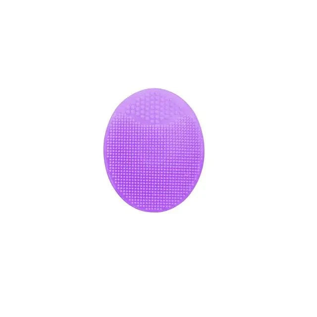 Purple silicone facial exfoliating cleansing brush with flexible bristles for deep skin cleaning.