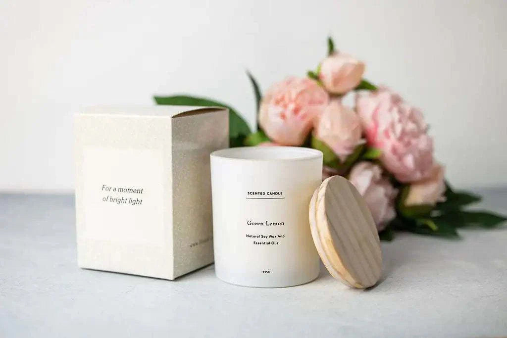 Valentine's Day gift luxury spa set with scented candle and pink flowers in background.