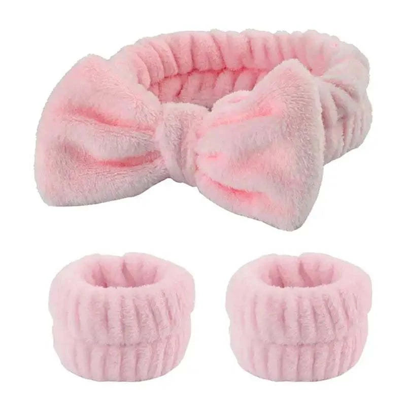 Plush pink bow hair and wristband set for skincare routine.
