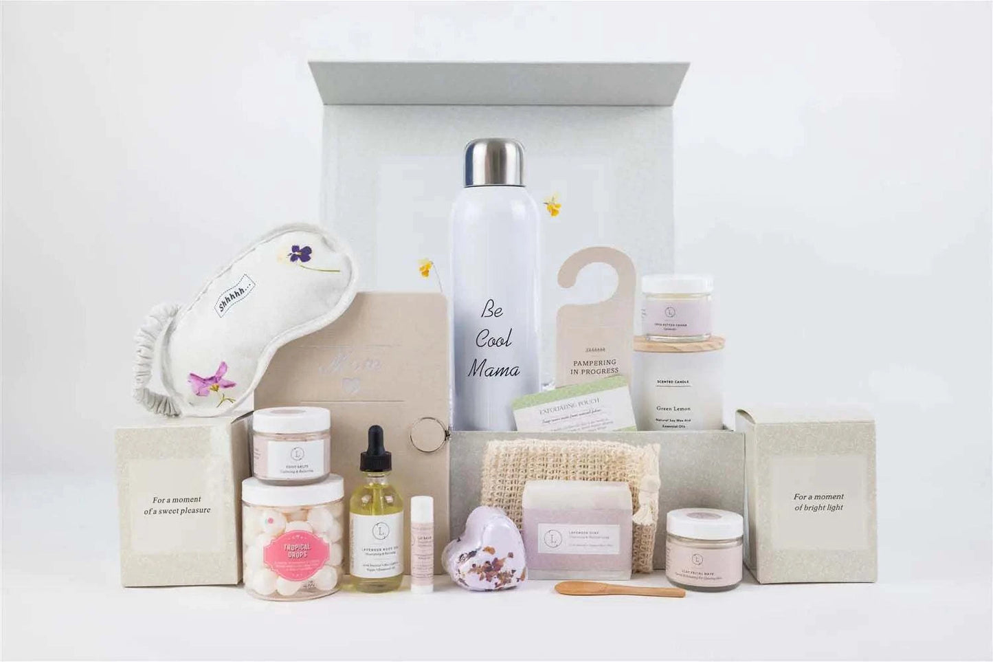 Mother's Day pamper gift set with journal, water bottle, scented candle, lavender items, and personalized options in an elegant box.