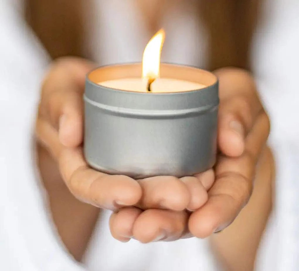 Christmas gift box candle held in hands, showcasing a cozy and warm holiday spirit.