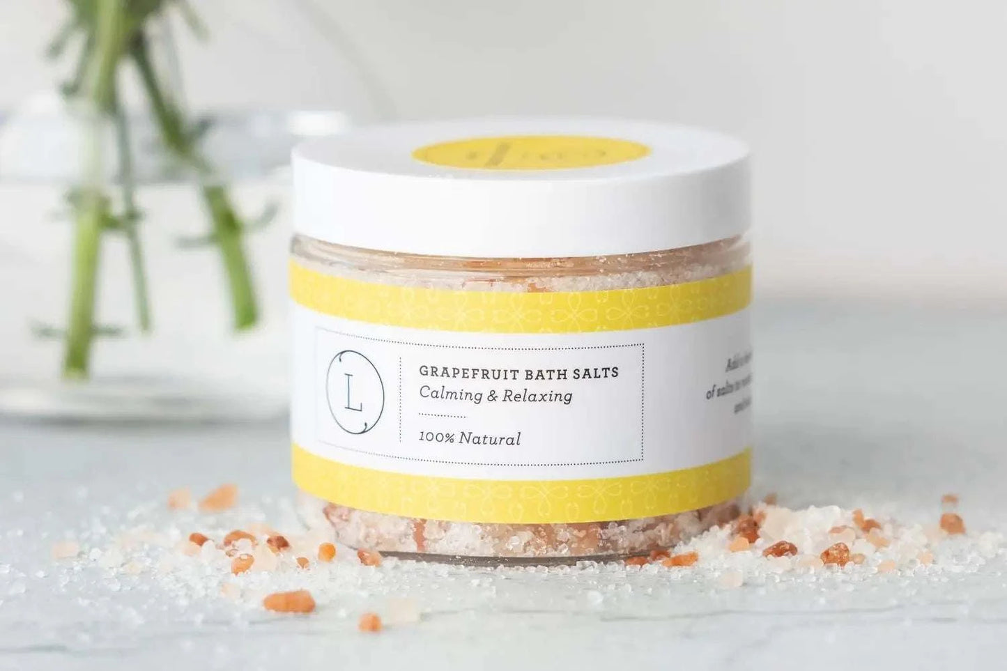 Grapefruit bath salts jar with calming and relaxing label, part of a celebration gift box.