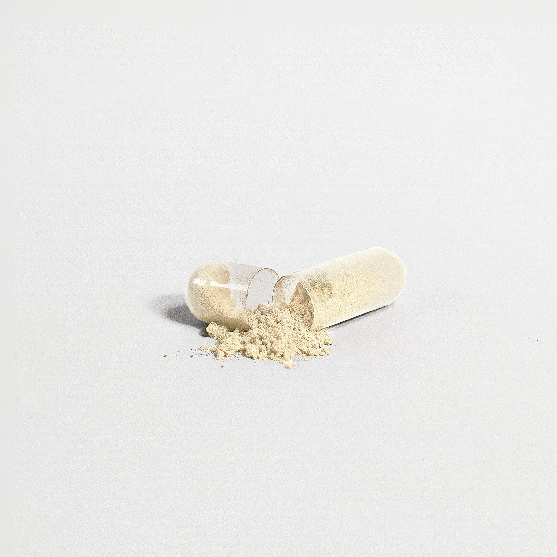 Gut Health dietary supplement capsule with exposed powder contents.